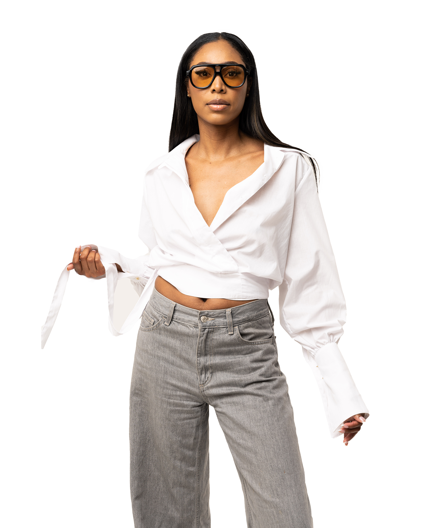 Woman wearing a white blouse and gray jeans on a white background